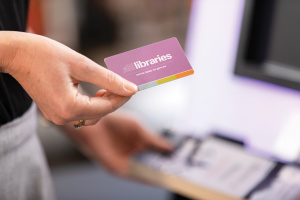 Woman holding Library Card